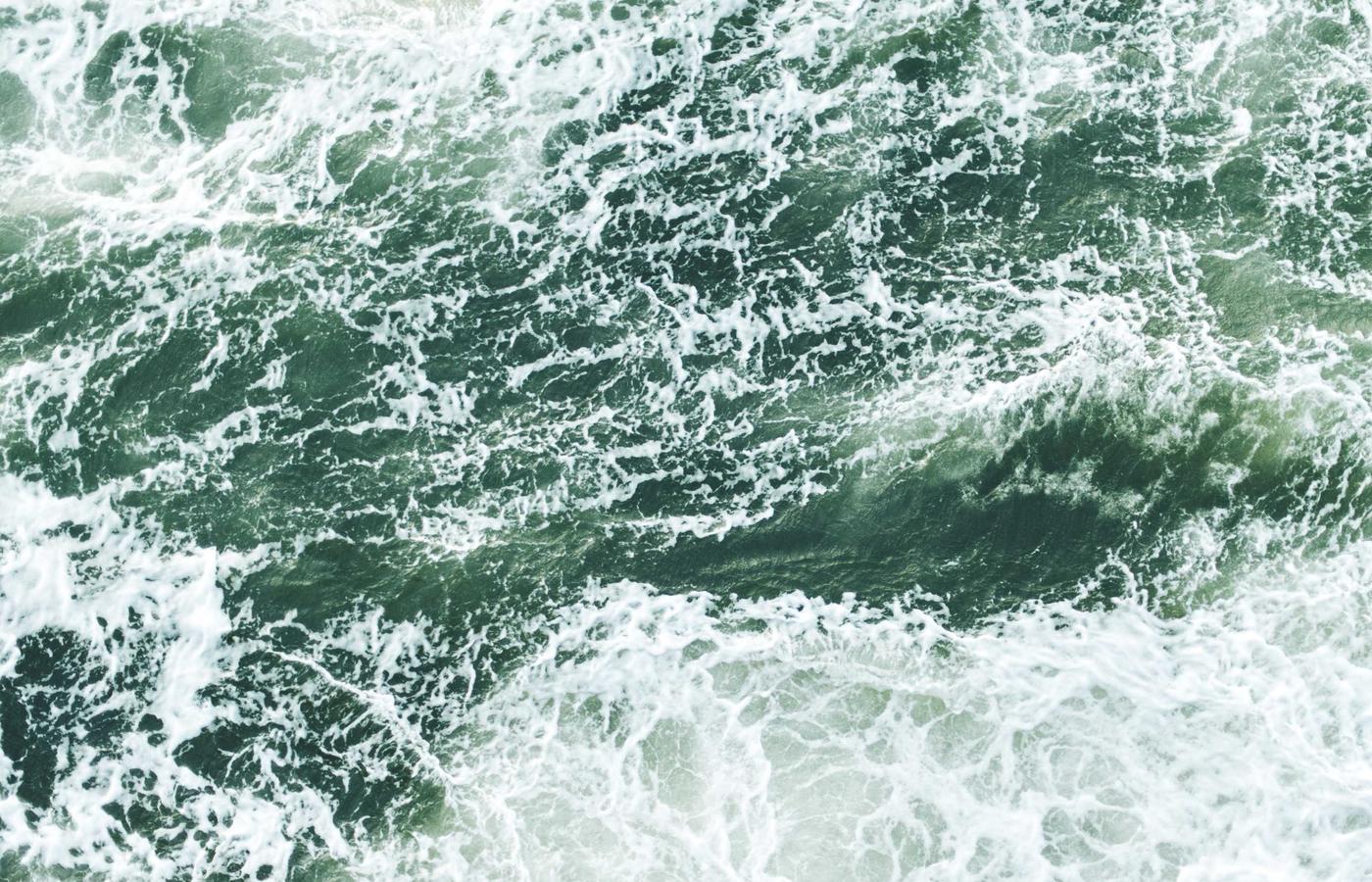 Technicians working on a satellite component in a clean room
